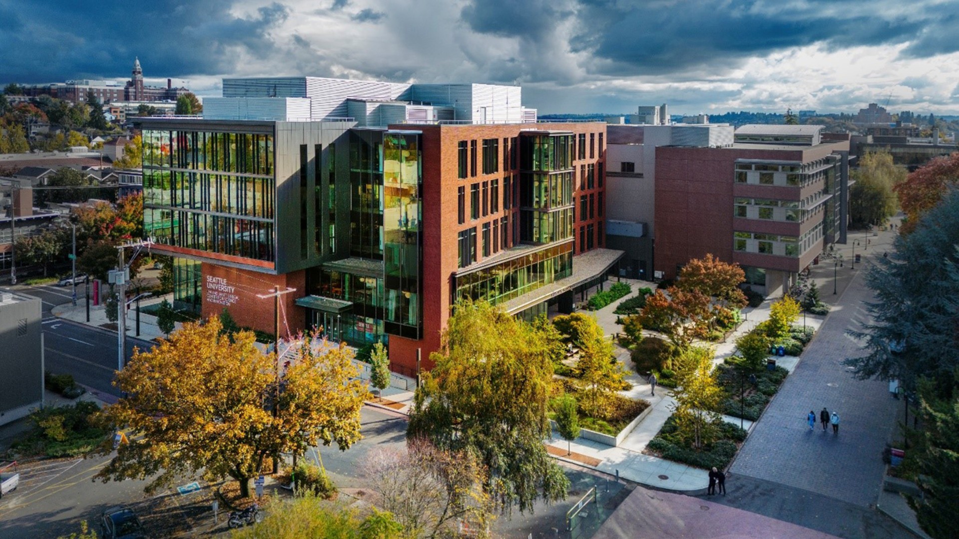 Seattle University – Sinegal Center for Science and Innovation Modern university building surrounded by autumn trees under a cloudy sky, providing an educational vibe.