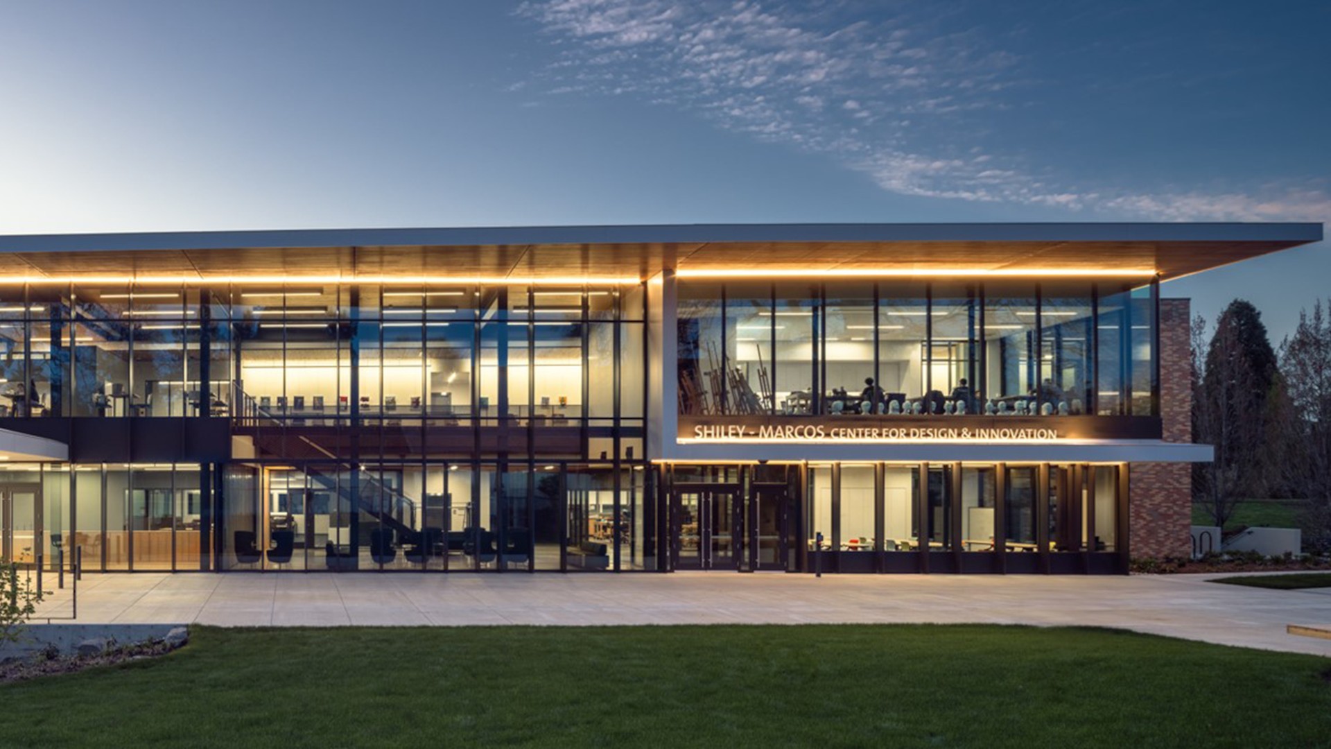 Modern Glass Building with Evening Lighting Exterior Modern building with large glass windows and illuminated interiors at dusk.