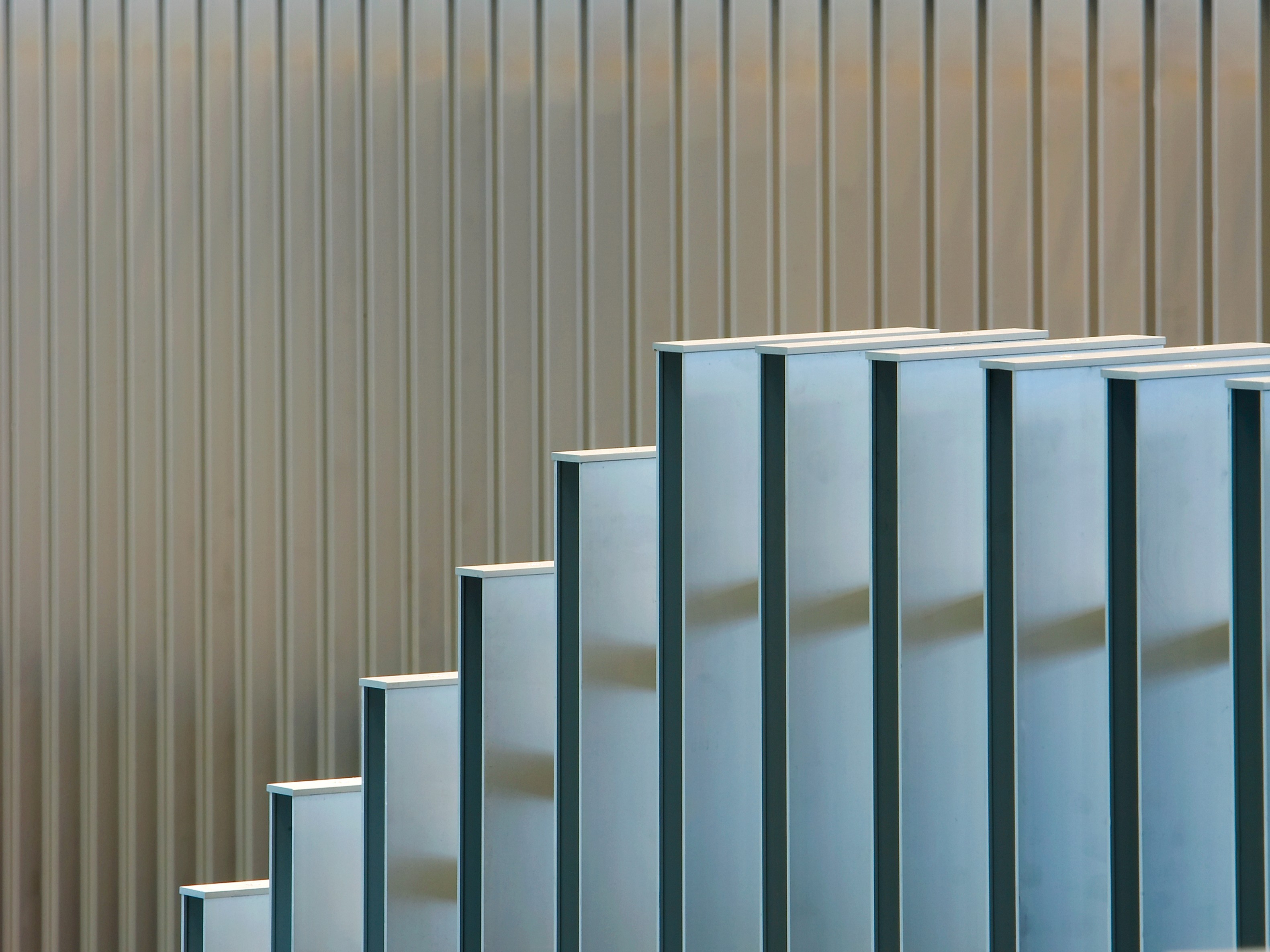 Modern architectural detail with vertical metal panels creating a dynamic, stepped pattern.