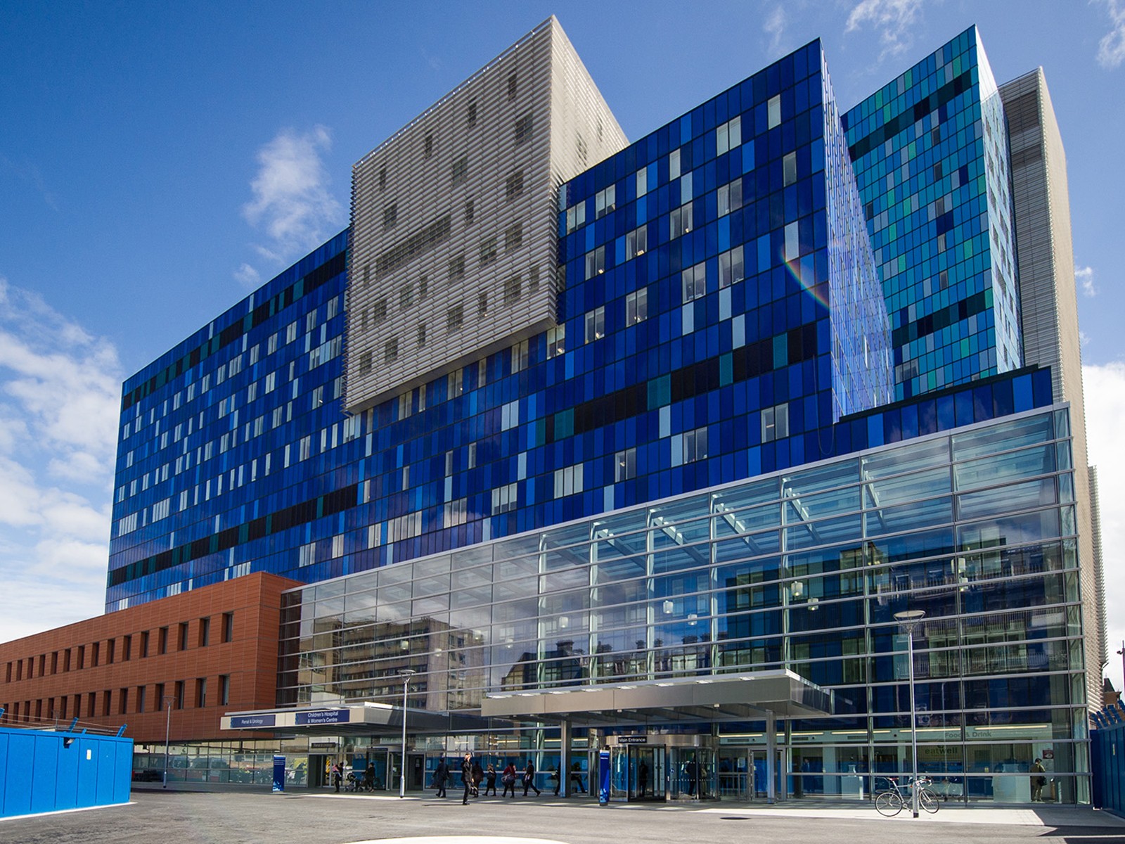 Fotot visar The Royal London Hospital Modern blåglashusbyggnad med stor entré och flervåningsarkitektur.