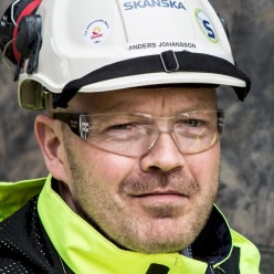 Anders Johansson A person wearing a Skanska helmet and a high-visibility jacket, indicating construction work.