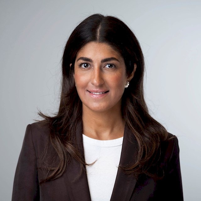 Hevi Eriksson Rehn Person with long dark hair wearing a black blazer and white top.