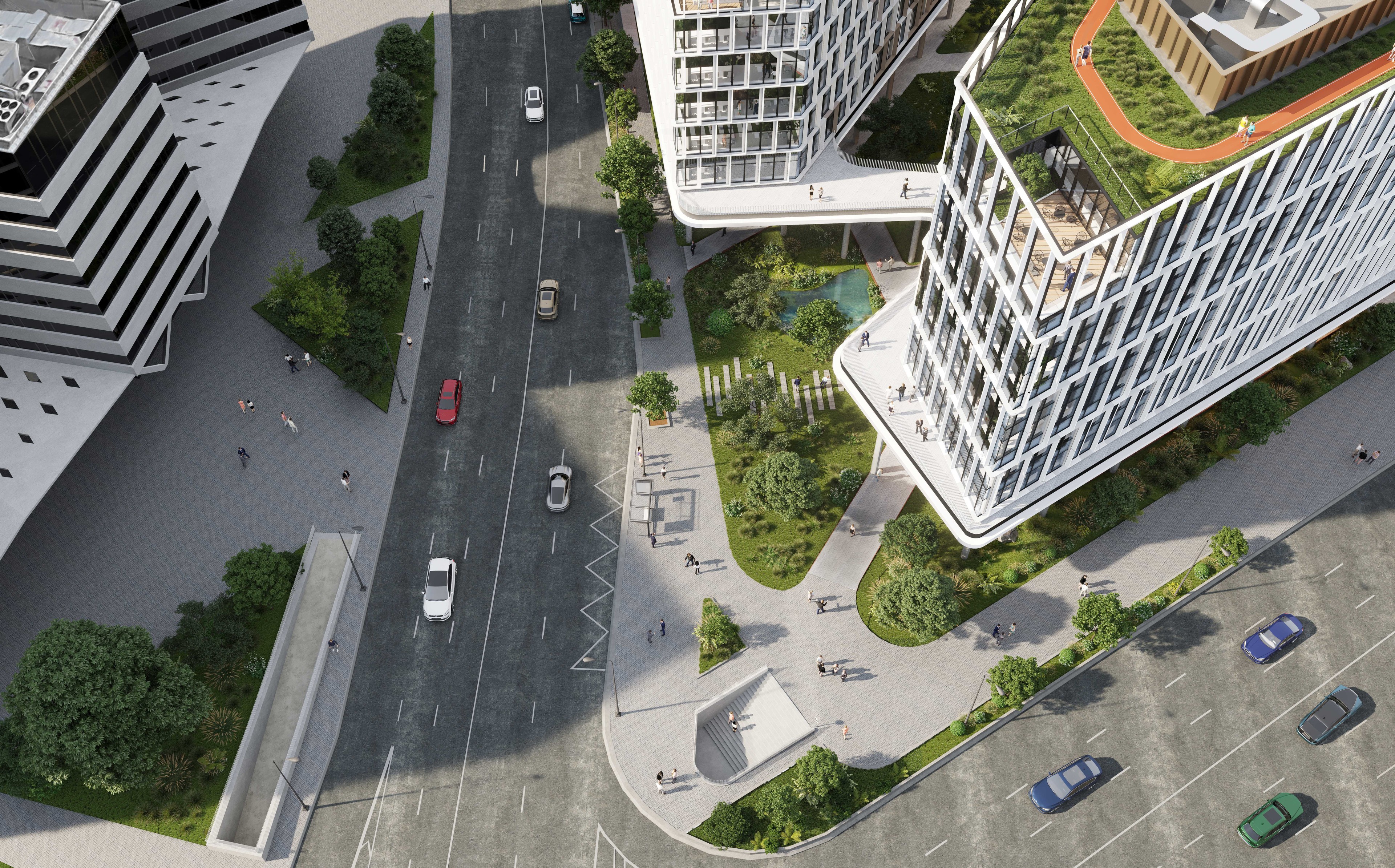 Modern office building with glass facade, surrounded by lush landscaping and pedestrian walkways.