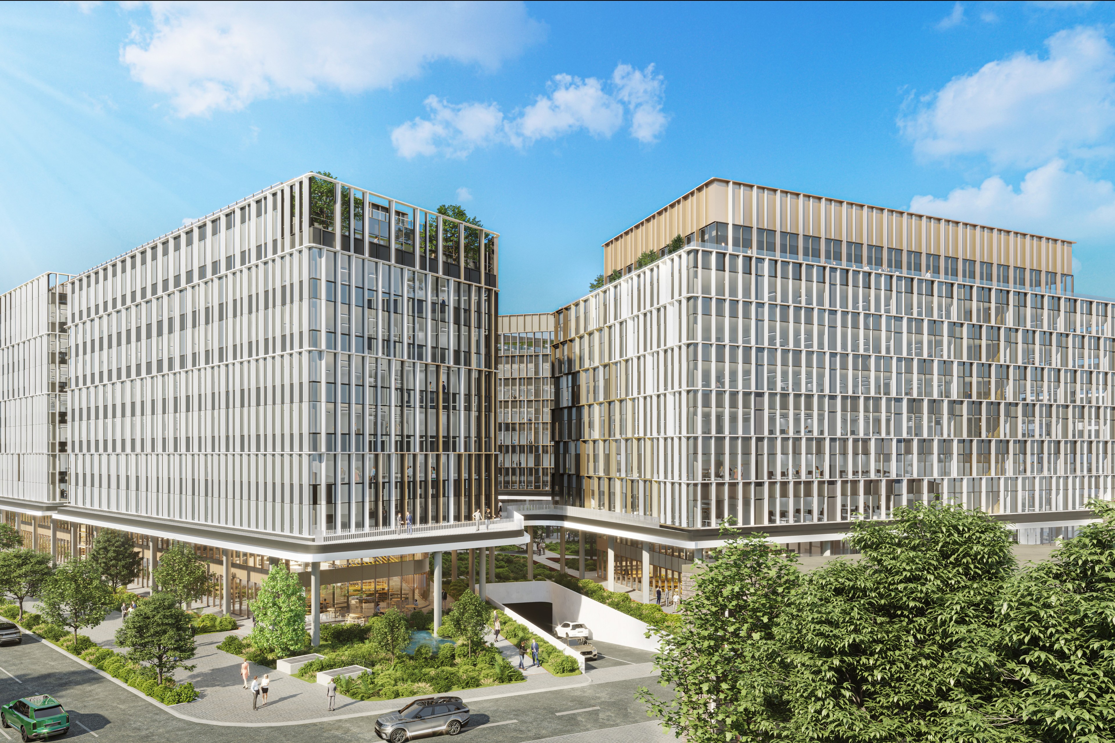 H₂Offices Phase 3 Modern office buildings with glass facades surrounded by greenery under a blue sky.