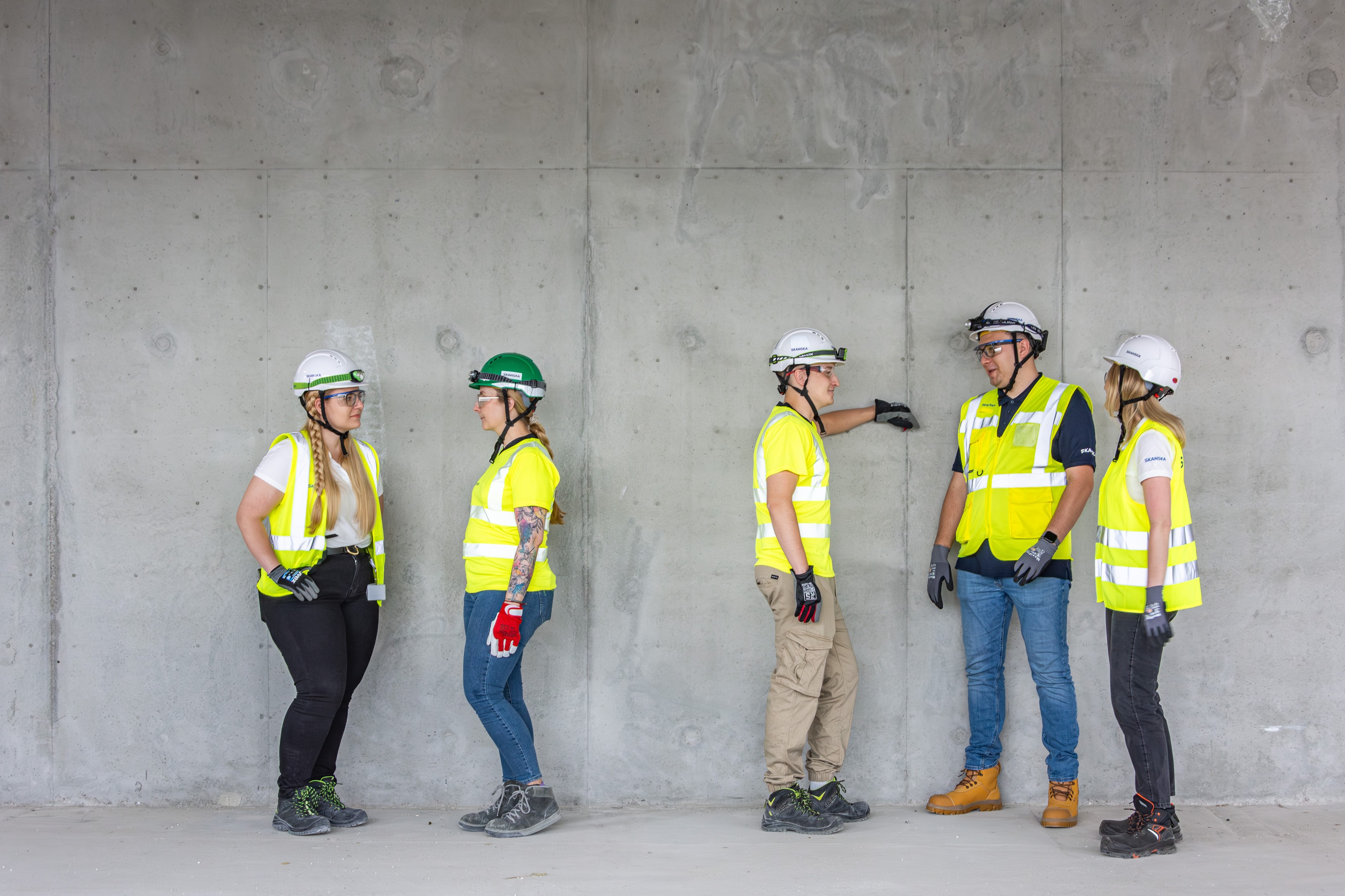 Construction workers in protective gear at the construction site Construction workers in protective gear at the construction site