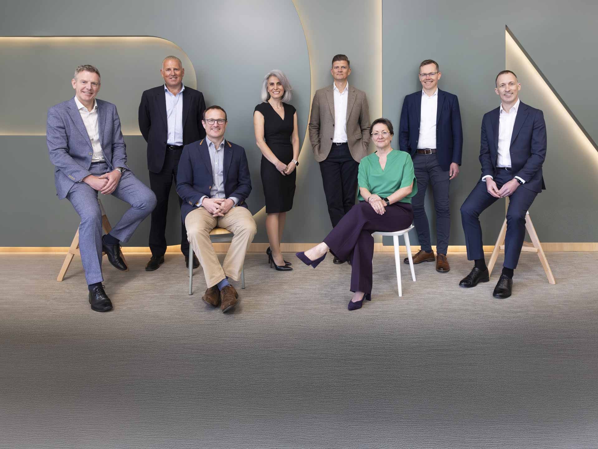 Professional diverse business team posing in modern office setting Group of professionally dressed businesspeople posing in a modern office setting.