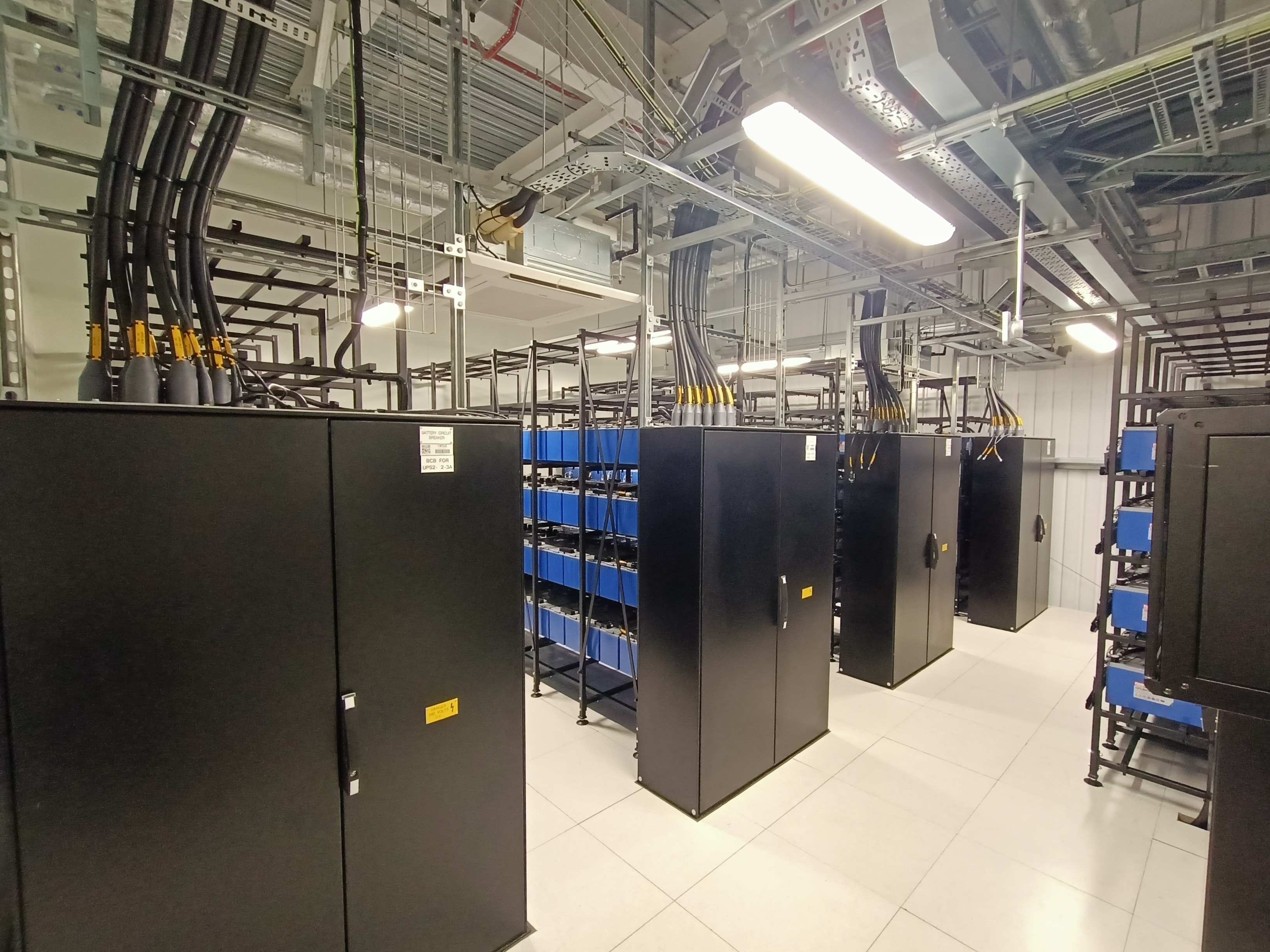 Modern Data Center with Server Racks and Cable Management Data center server racks with organized cabling and cooling infrastructure.