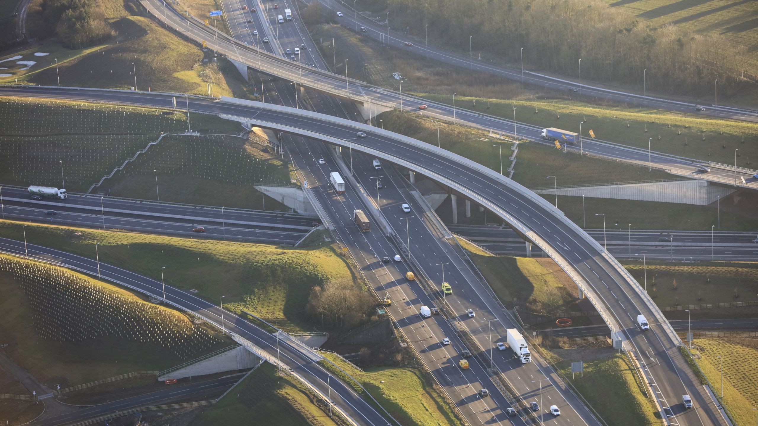 Aerial view of a busy highway interchange with multiple overpasses and vehicles.