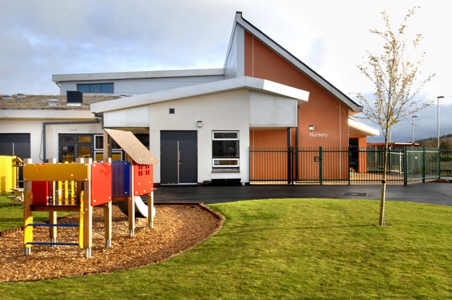 Modern Nursery Building with Outdoor Playground and Green Lawn Modern nursery building with colorful playground equipment and green lawn.