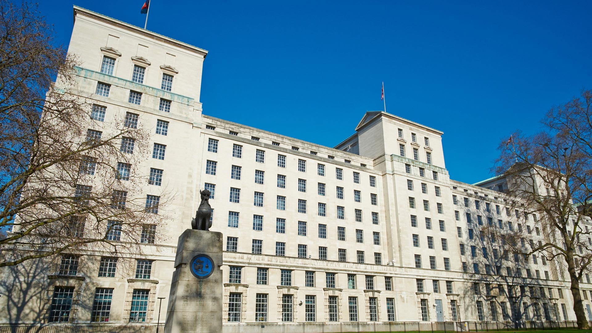 The Ministry of Defence (MOD) Whitehall project entailed a complete refurbishment of the Grade II listed building British Ministry of Defence building with Union Jack flags against a clear blue sky.