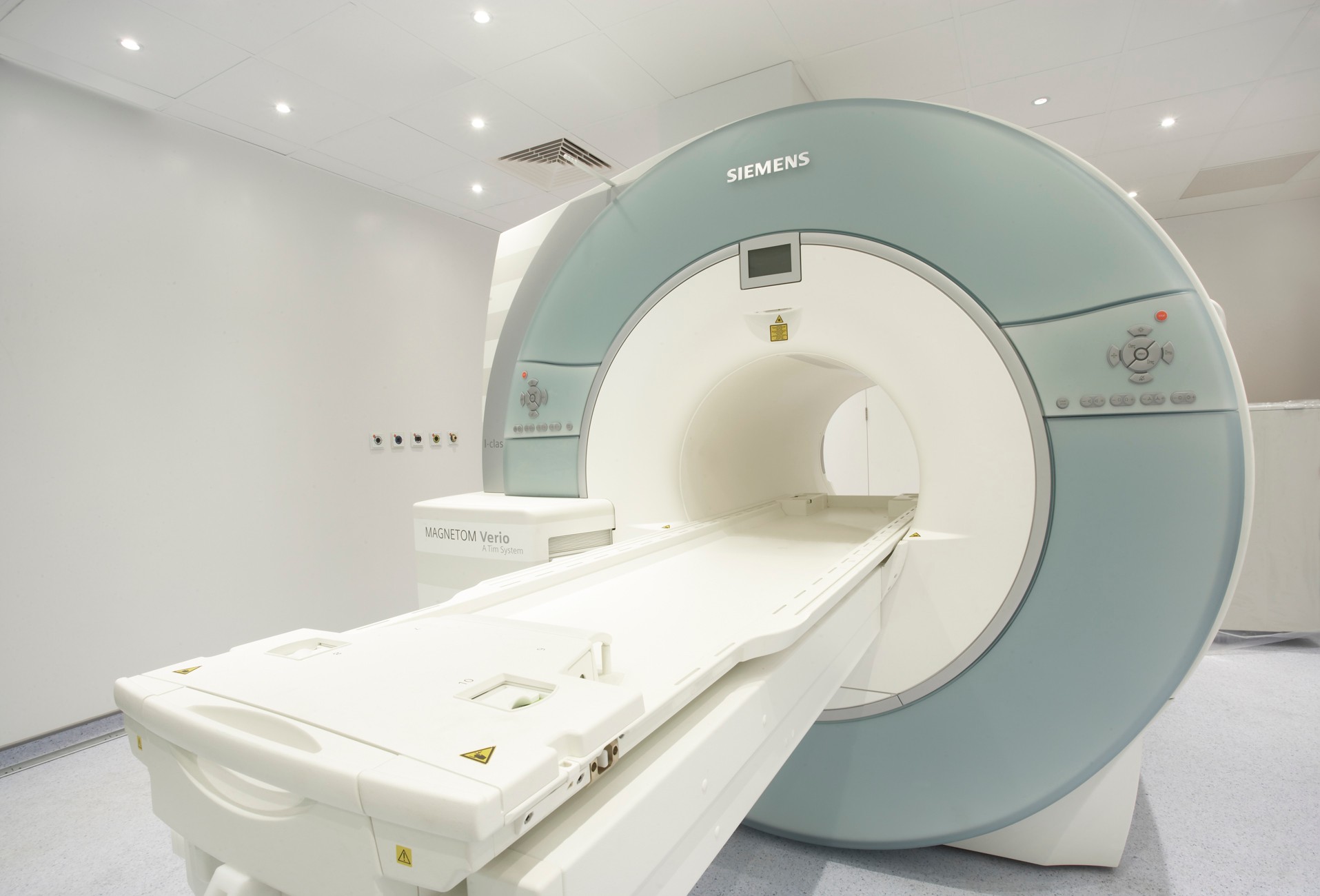 MRI scanner machine in a clean, well-lit medical imaging room.
