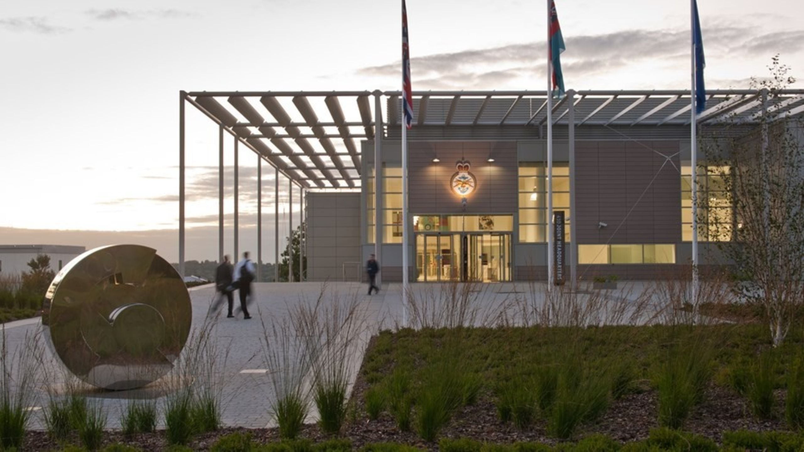 Building with flags and sunset.
