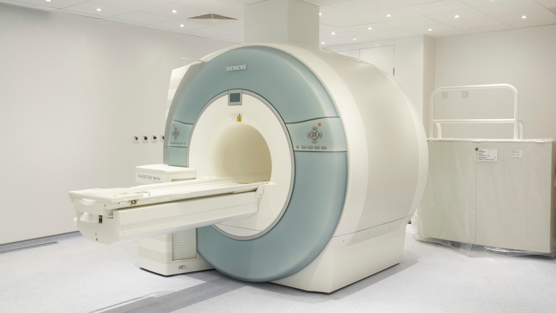 Advanced Siemens MRI Scanner in Modern Medical Facility MRI scanner machine in a clean, modern medical imaging room with bright lighting.