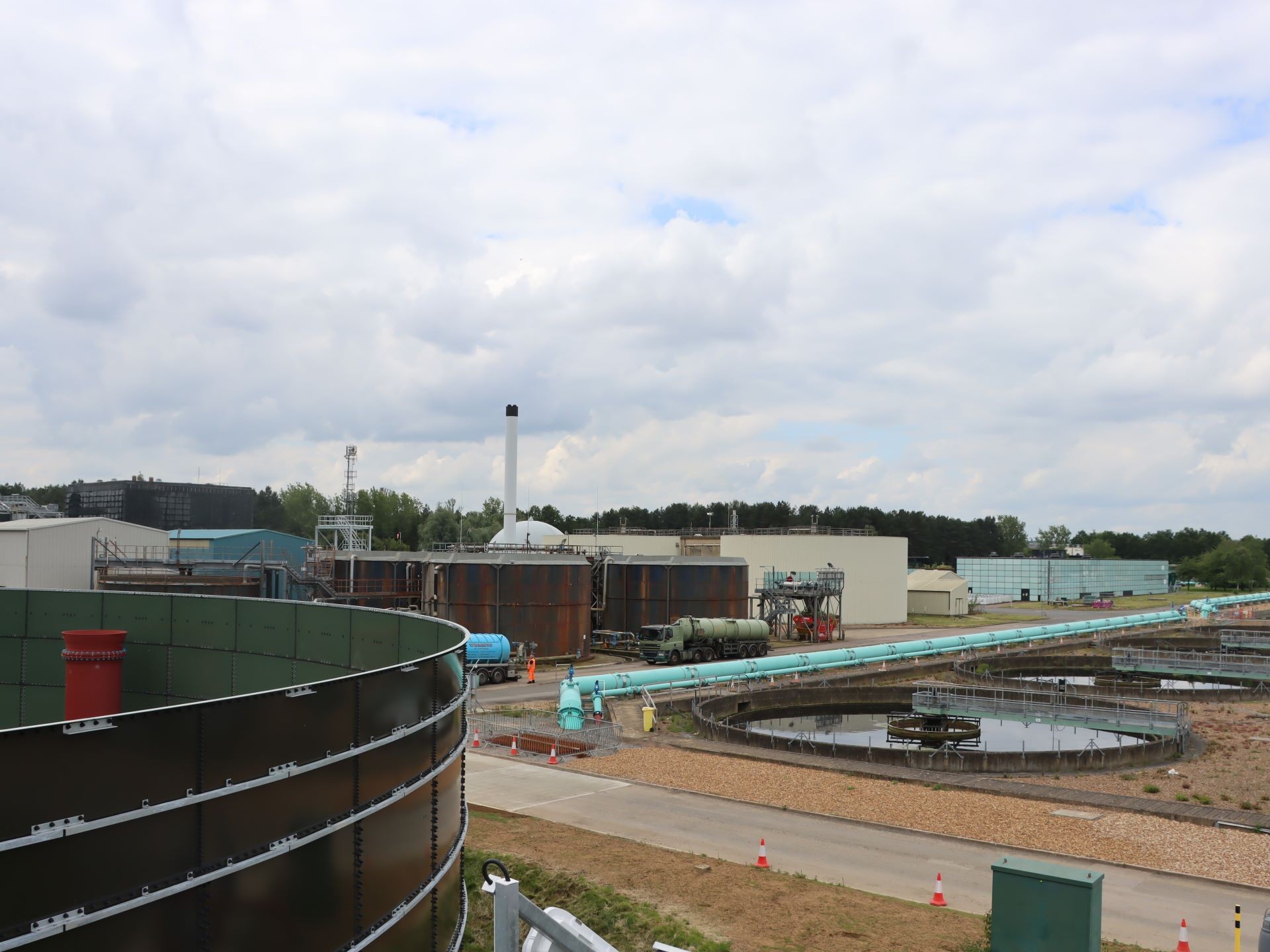 Modern Wastewater Treatment Plant with Large Storage Tanks (Cotton Valley) Industrial water treatment plant with large tanks and pipes under a cloudy sky (Cotton Valley)