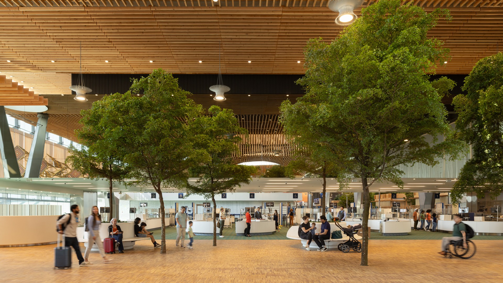 Modern Airport Interior with Green Trees and Travelers Modern airport terminal interior with lush green trees, travelers, and contemporary architecture.
