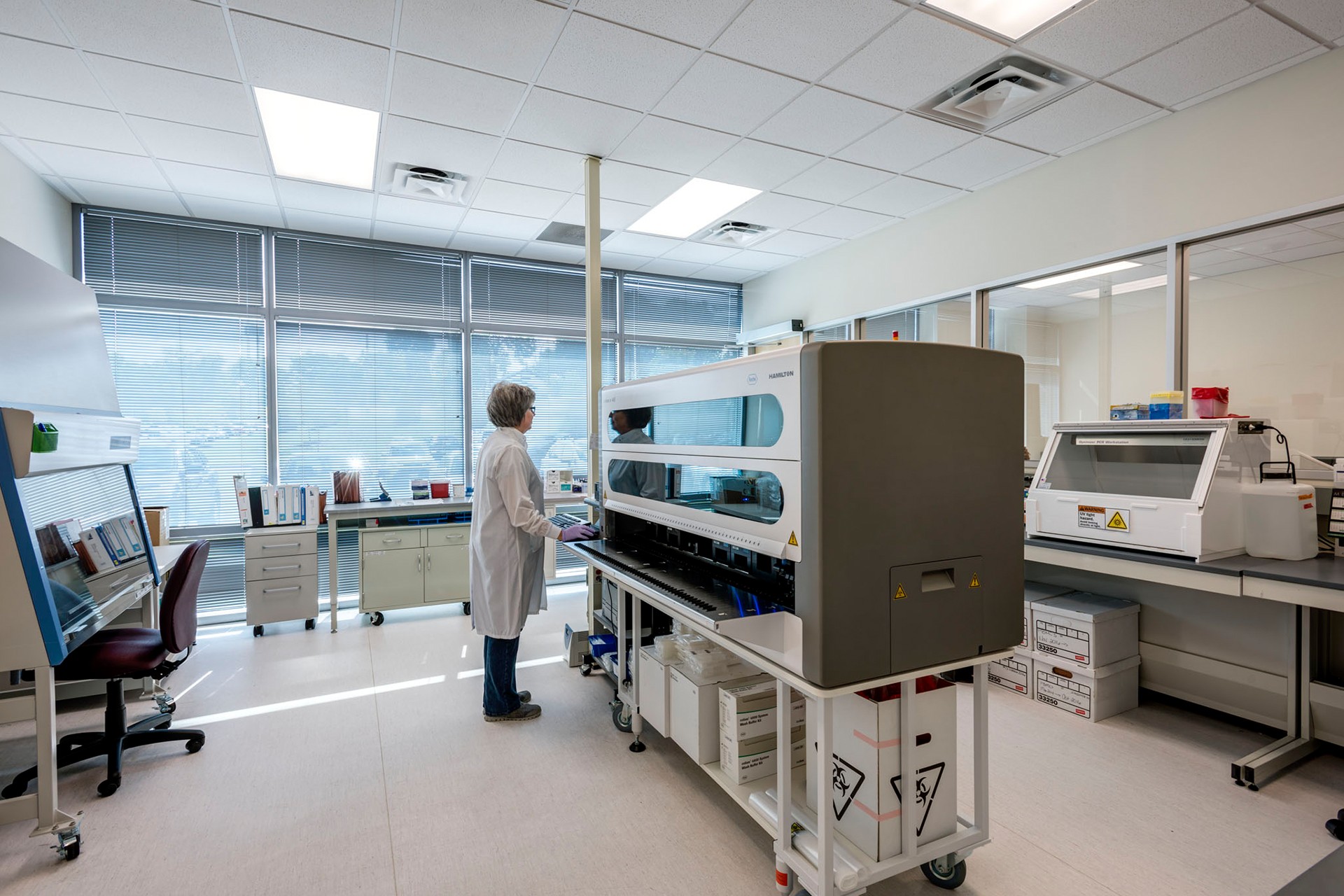 Woman works at a lab station in a pharmaceutical laboratory Woman works at a lab station in a pharmaceutical laboratory