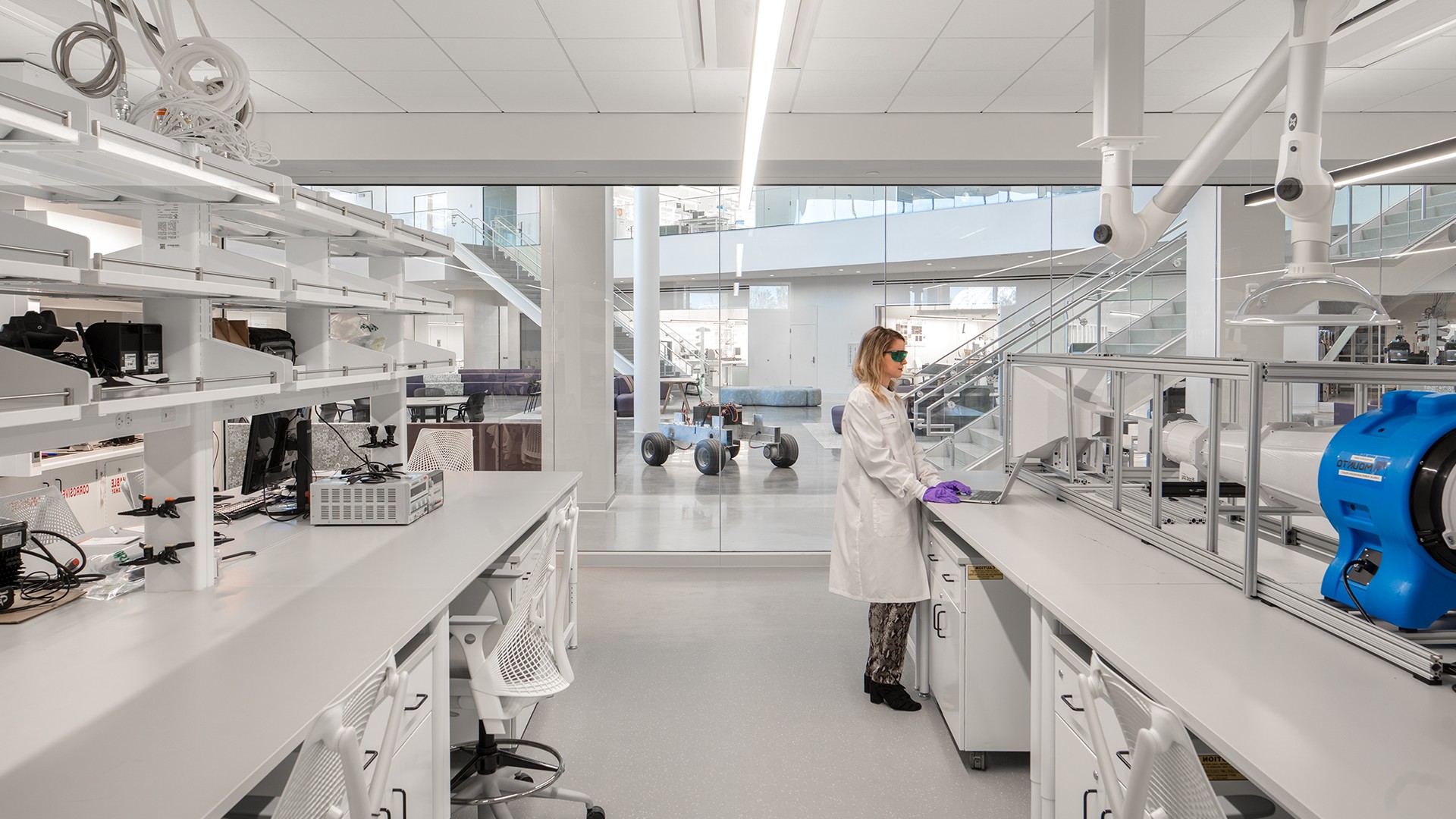 Woman working in a clean room lab Woman working in a clean room lab