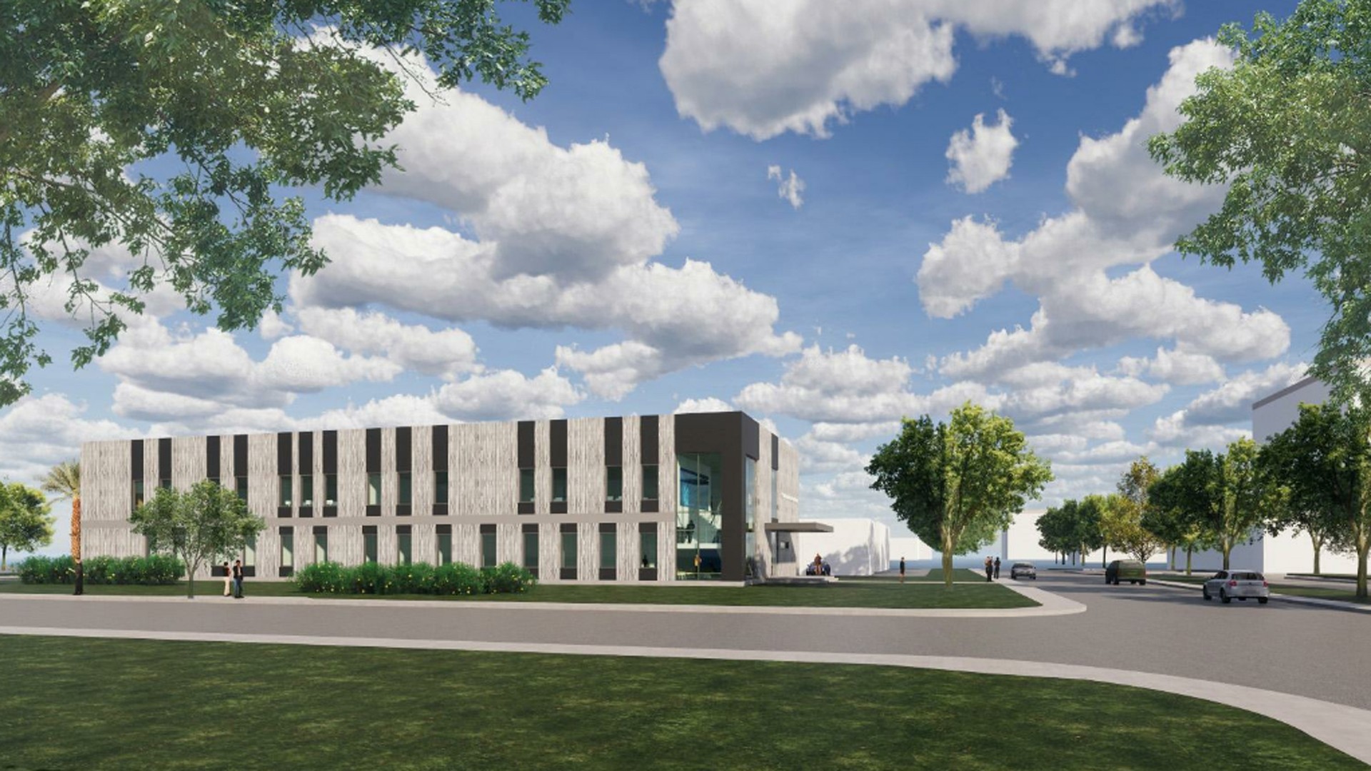 Modern office building with trees and blue sky in a spacious urban environment.