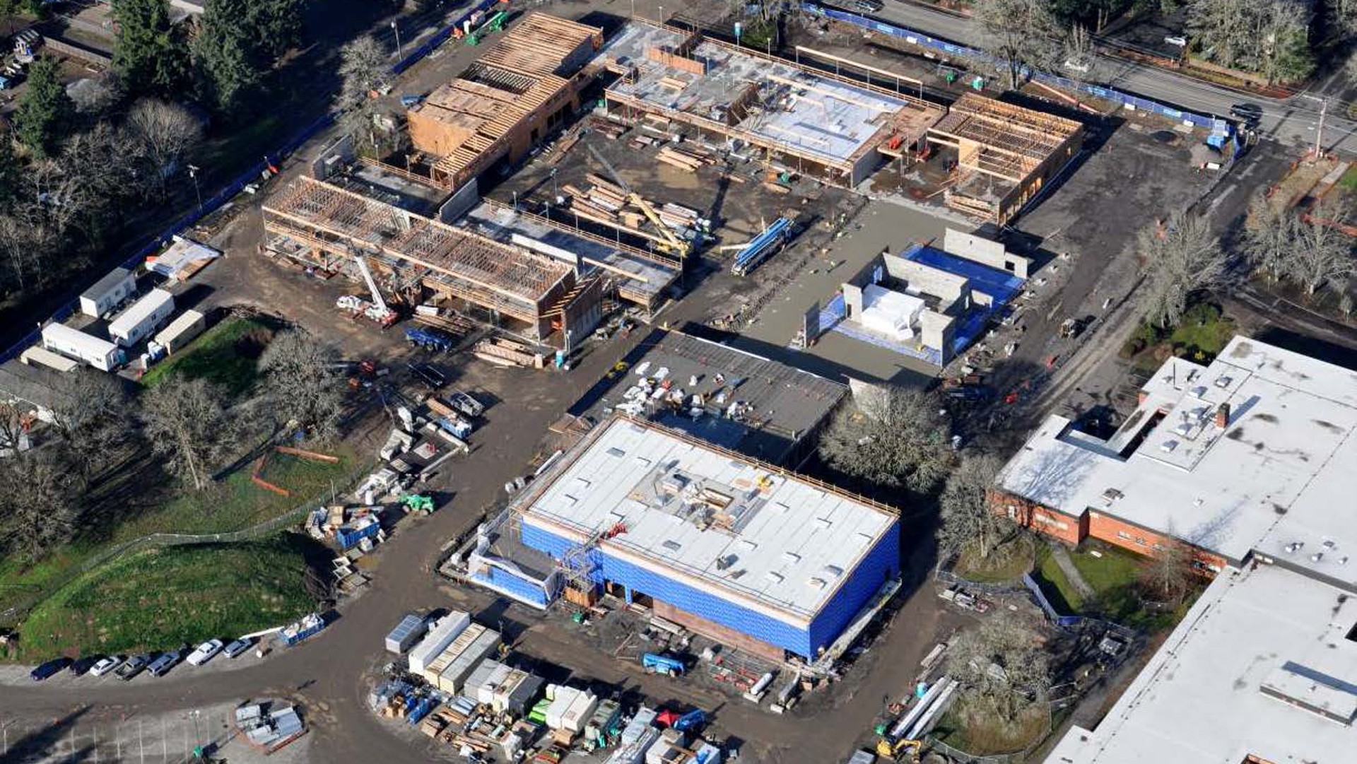 Aerial view of a large construction site with multiple buildings in progress.
