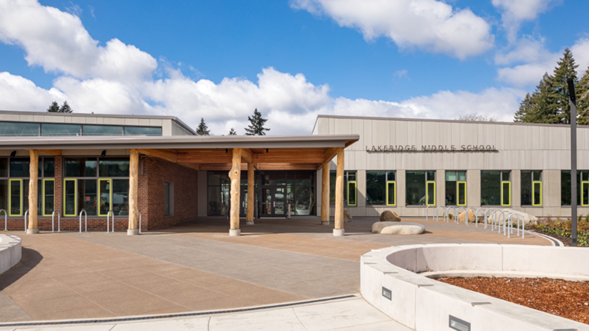 Modern Lakeside Middle School building entrance with bike racks and clear sky.