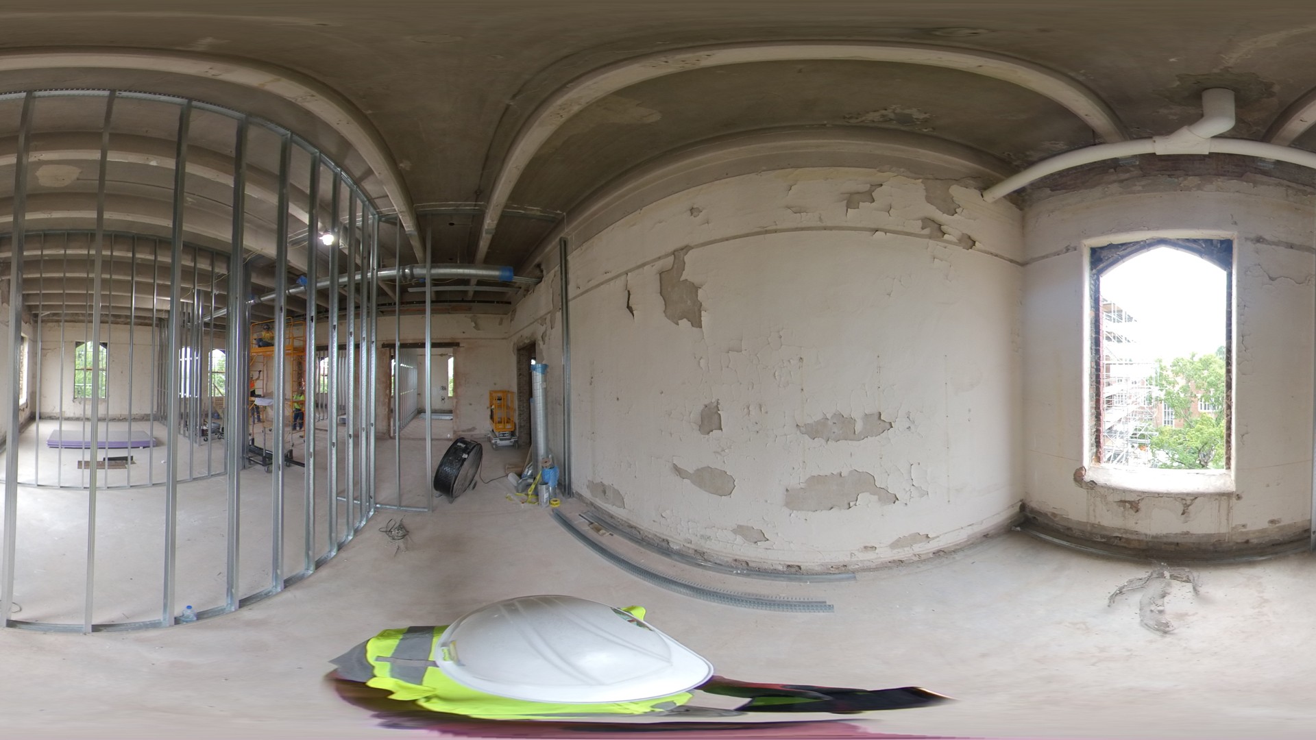Interior of an unfinished room under construction with metal framing and exposed walls.