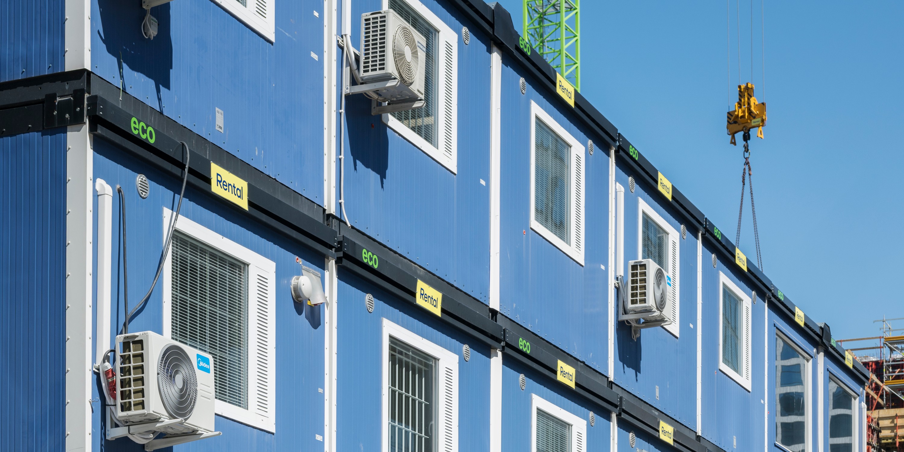 Blue modular buildings with air conditioners, labeled "Rental".