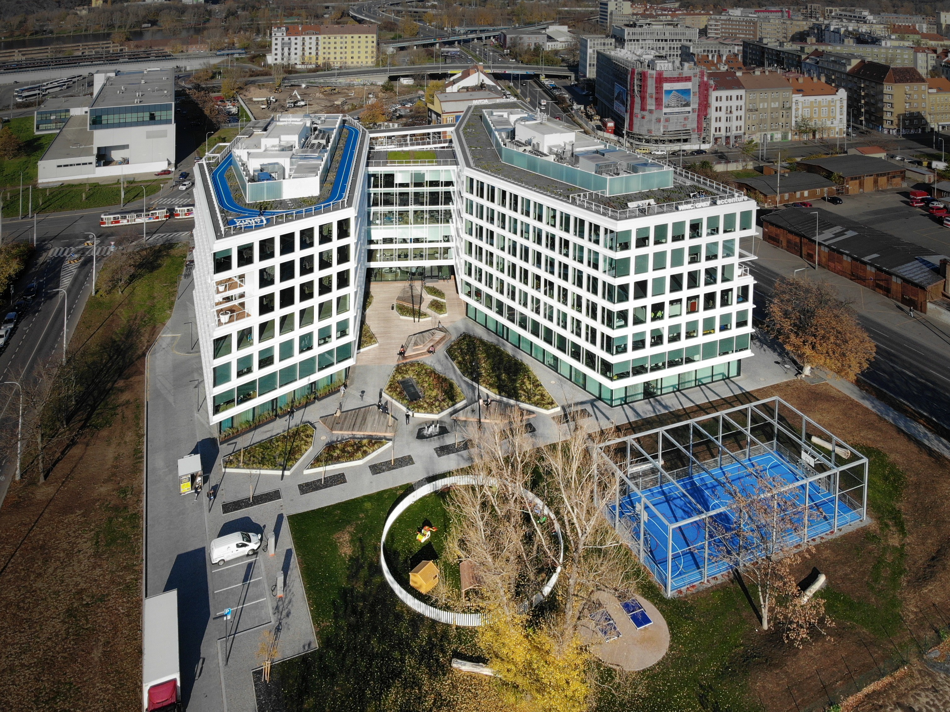 Bird's eye view of the Visionary building Modern office building with large windows and rooftop terraces in an urban environment.