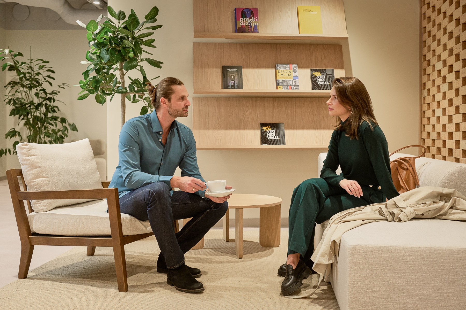 Two people having a conversation, sitting in a modern, cozy living room.