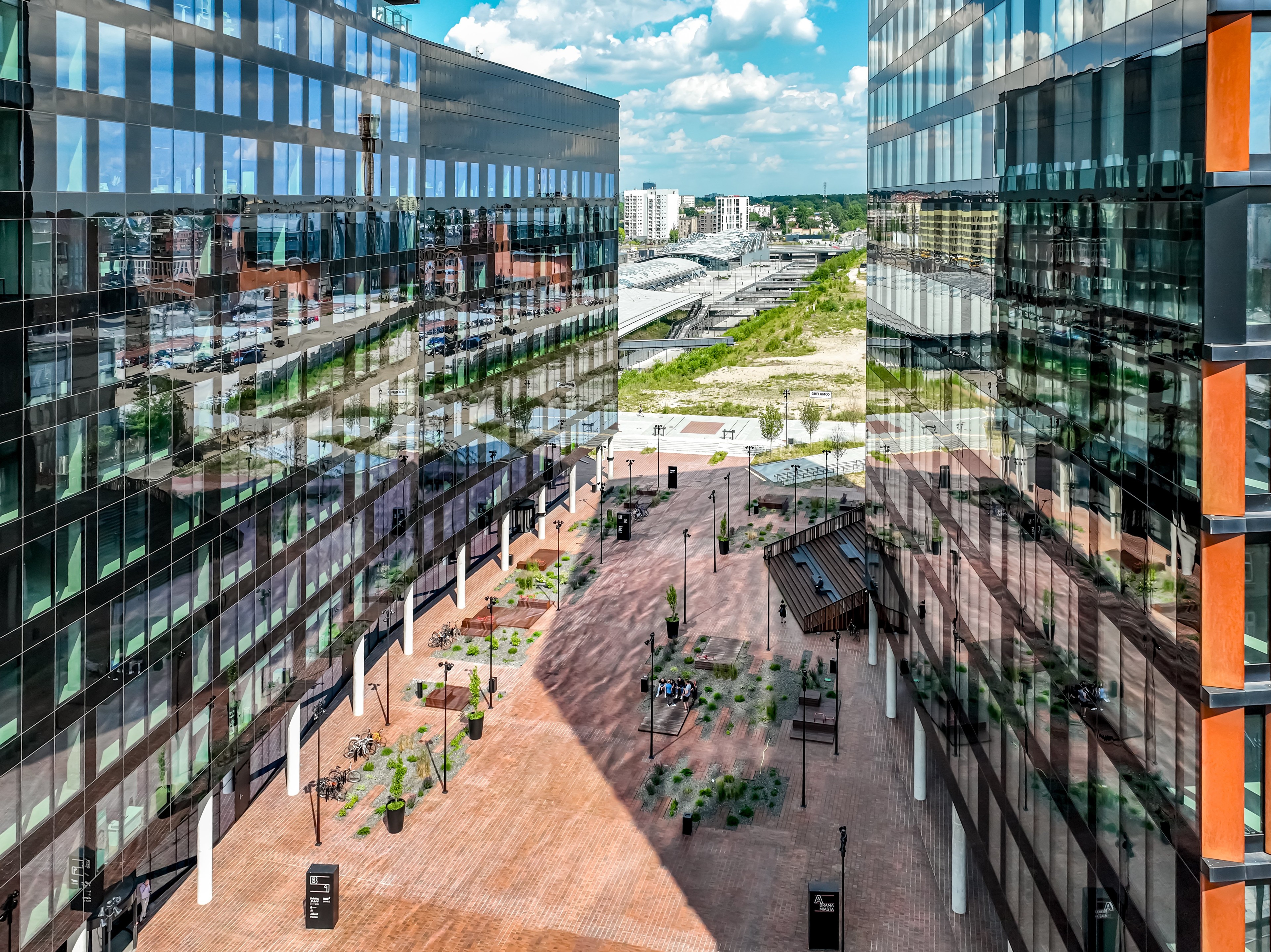 Modern glass architecture: slender urban office buildings Modern skyscrapers against a clear sky, showcasing urban architecture and design.