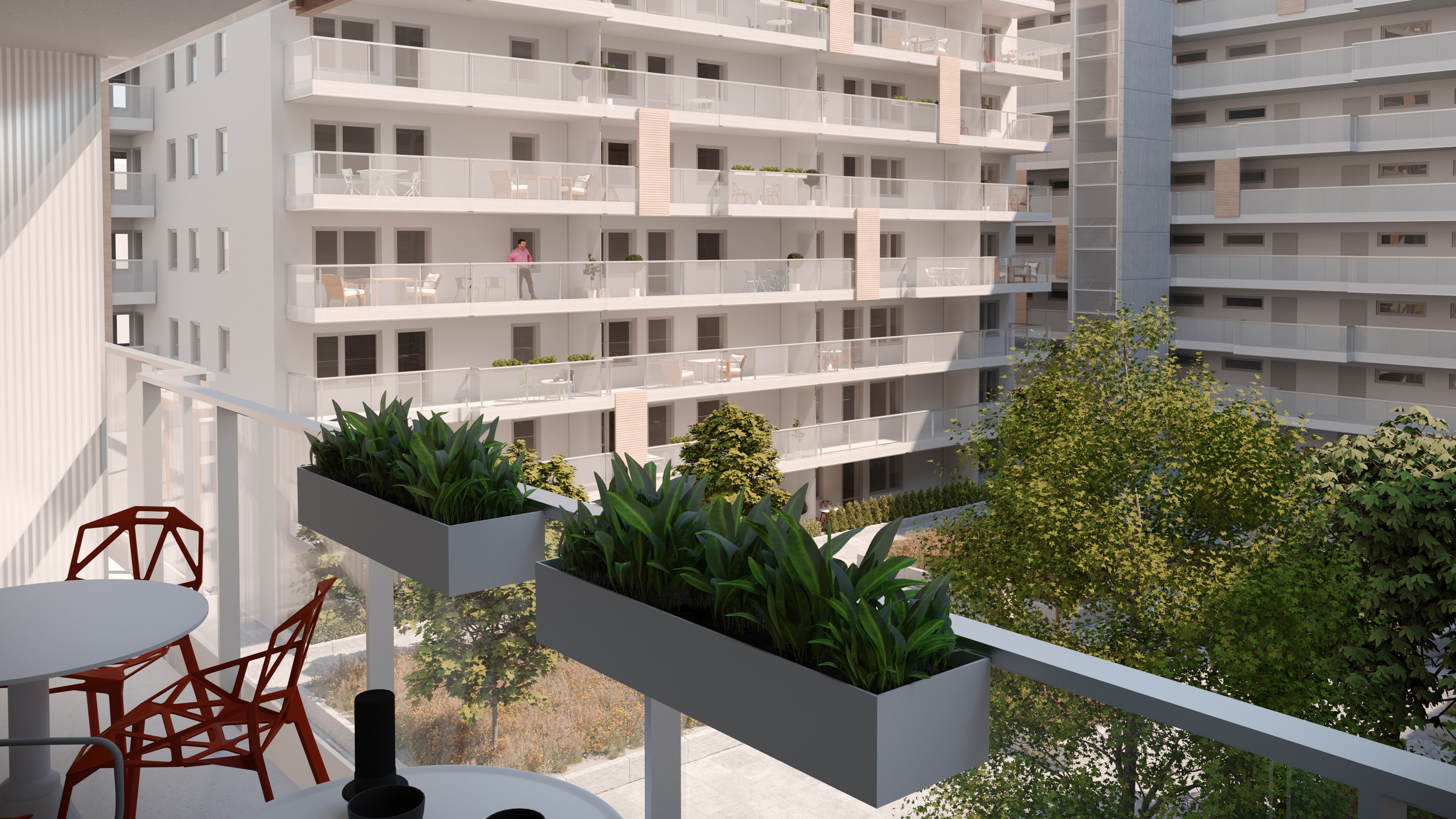 Vy från en av balkongerna i Tändstickan. Modern lägenhetsbalkong med utsikt, krukväxter, sittområde och intilliggande bostadshus.