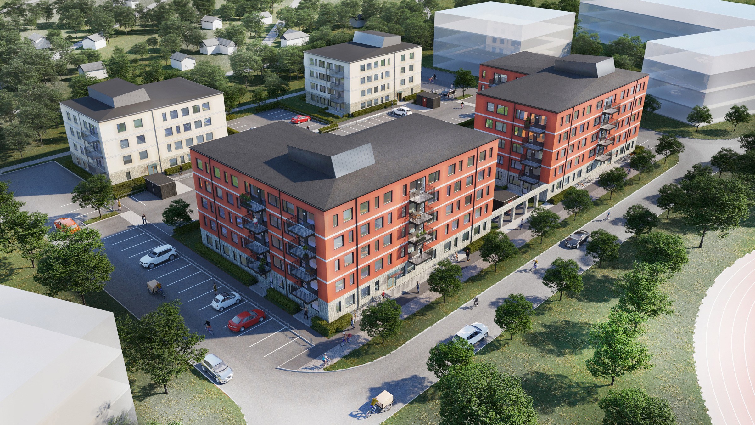 Flygvy över moderna bostadsbyggnader med parkering och grönområden i en stadsmiljö.