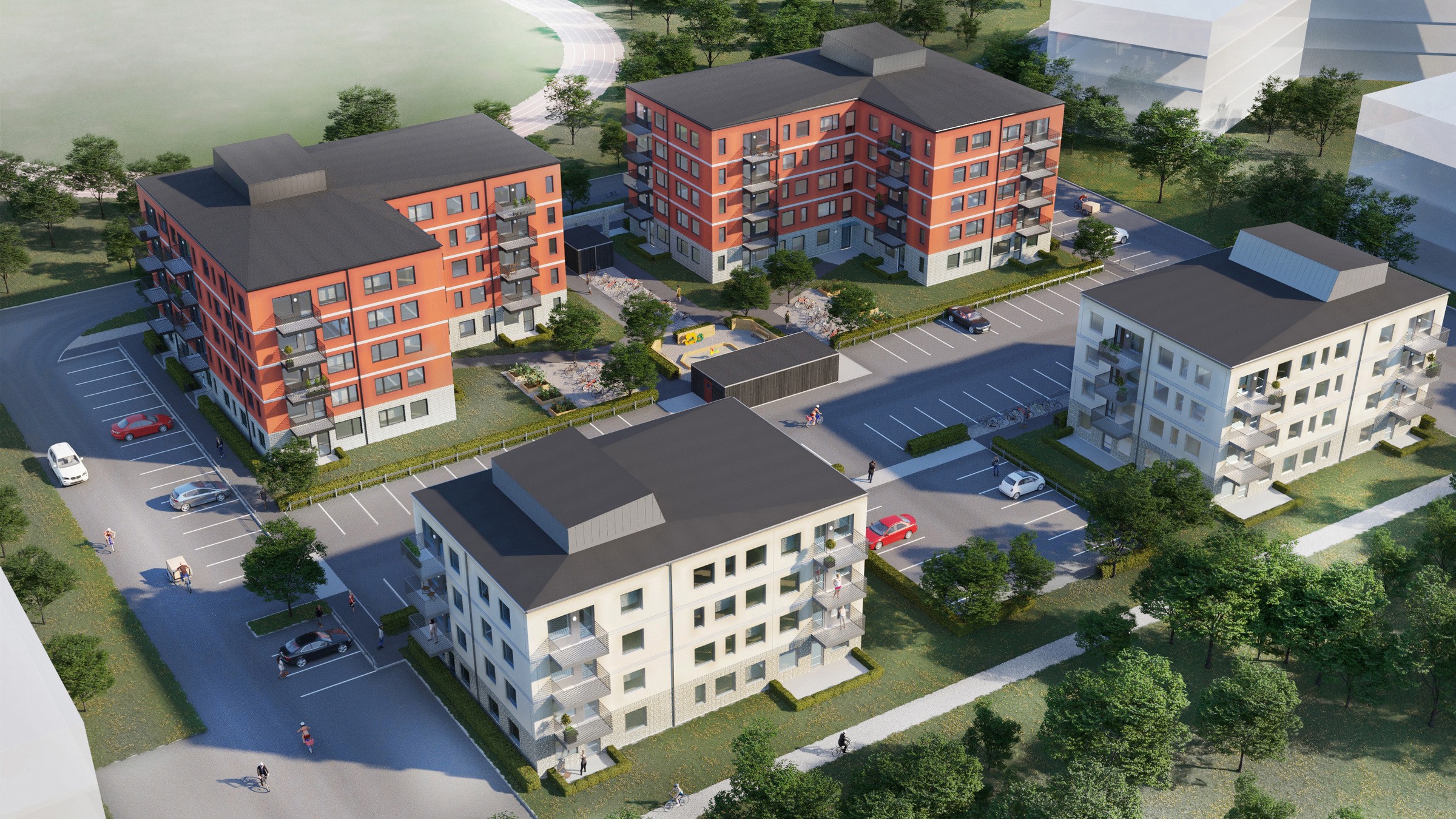 Flygfoto av modernt lägenhetskomplex med parkering och anlagda områden, som visar stadsliv.