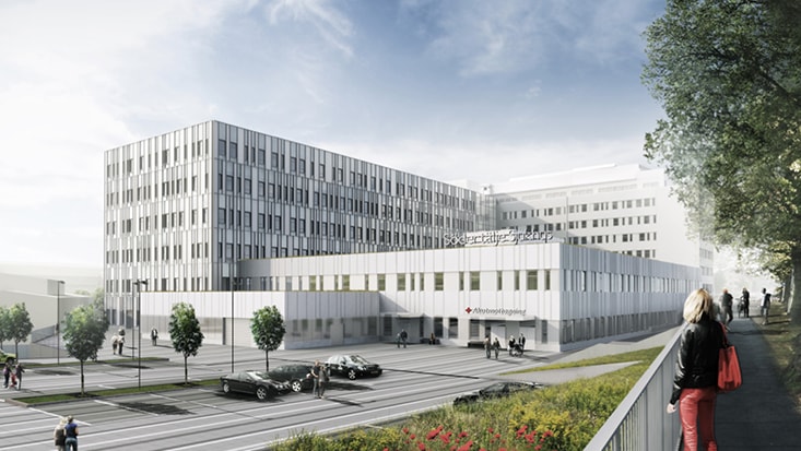 Modern sjukhusbyggnad med flervåningshus, träd och människor som promenerar i närheten.