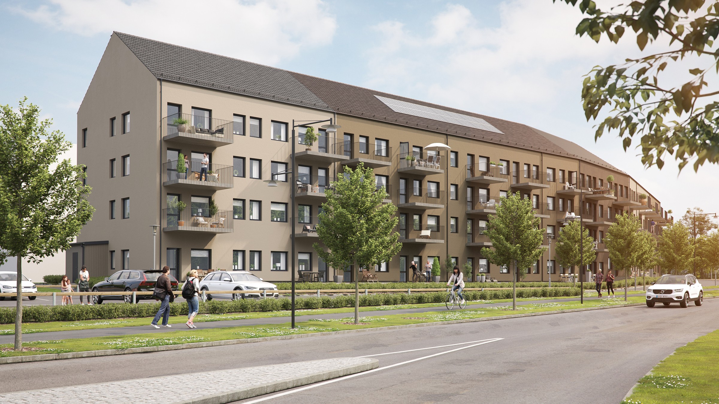 Modern lägenhetsbyggnad med balkonger, träd och gatutsikt under en klar himmel.
