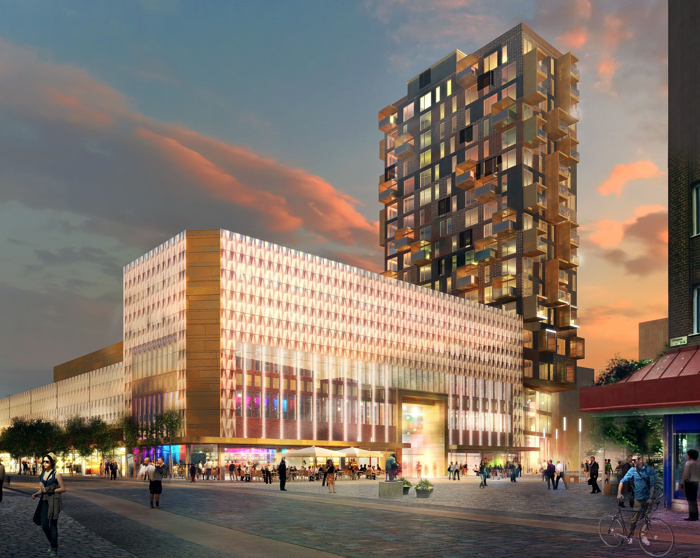 Gallerian Söderpunkten kommer att bidra till att södra Helsingborg blir ett mer attraktivt och levande område. Modern byggnad med blandad användning med upplyst fasad och torn vid solnedgången, med urban aktivitet.