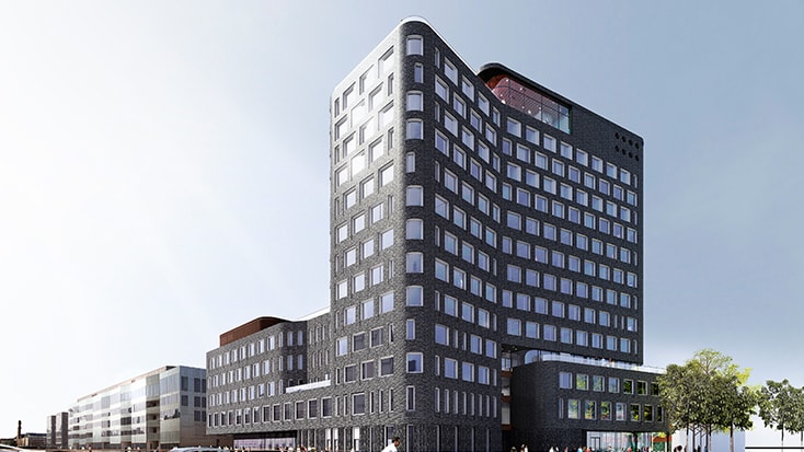 Kv Tyfonen Modern flervåningsbyggnad med mörk fasad och många fönster i en solig stadsmiljö.