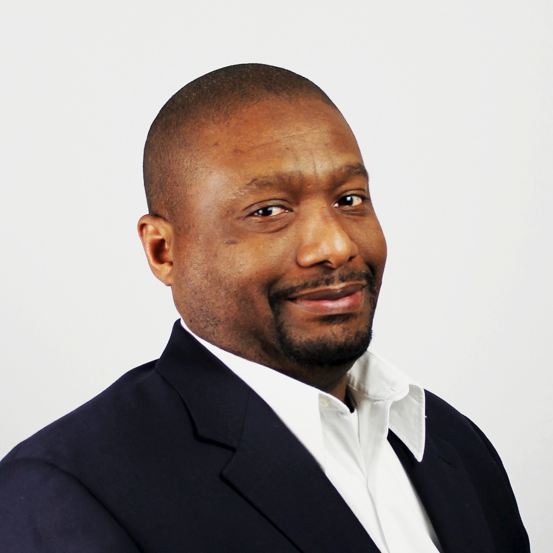 Professional Black Man in Suit and White Shirt Portrait Professional man in dark suit jacket and white shirt against a plain background.