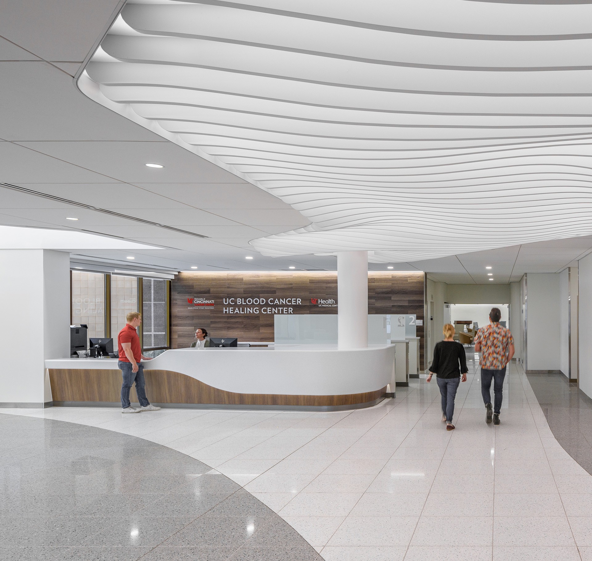 Modern UC Blood Cancer Healing Center Reception Area Modern hospital reception area at UC Blood Cancer Healing Center with staff and visitors.