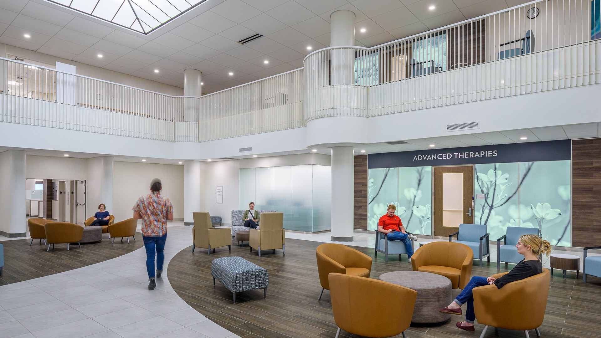 Modern medical clinic waiting area with comfortable seating and patients.