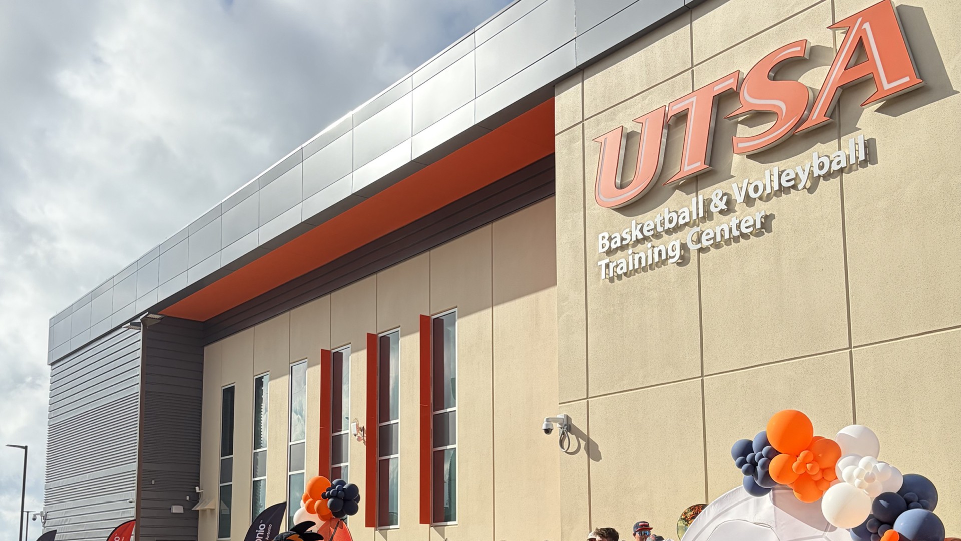 UTSA Basketball & Volleyball Training Center exterior with balloons and clear sky.