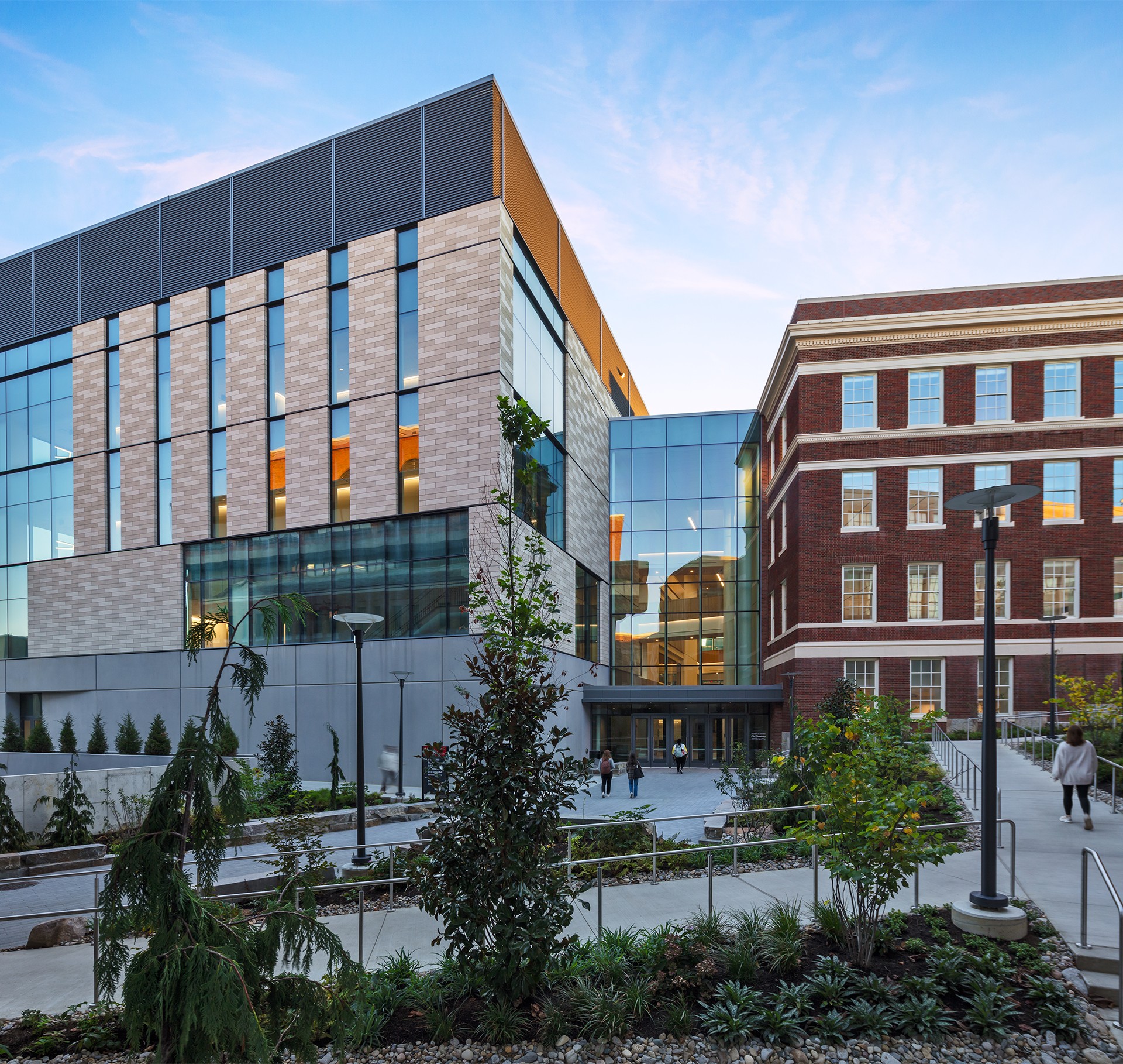 Exterior shot of a higher education academic building with trees and pathways