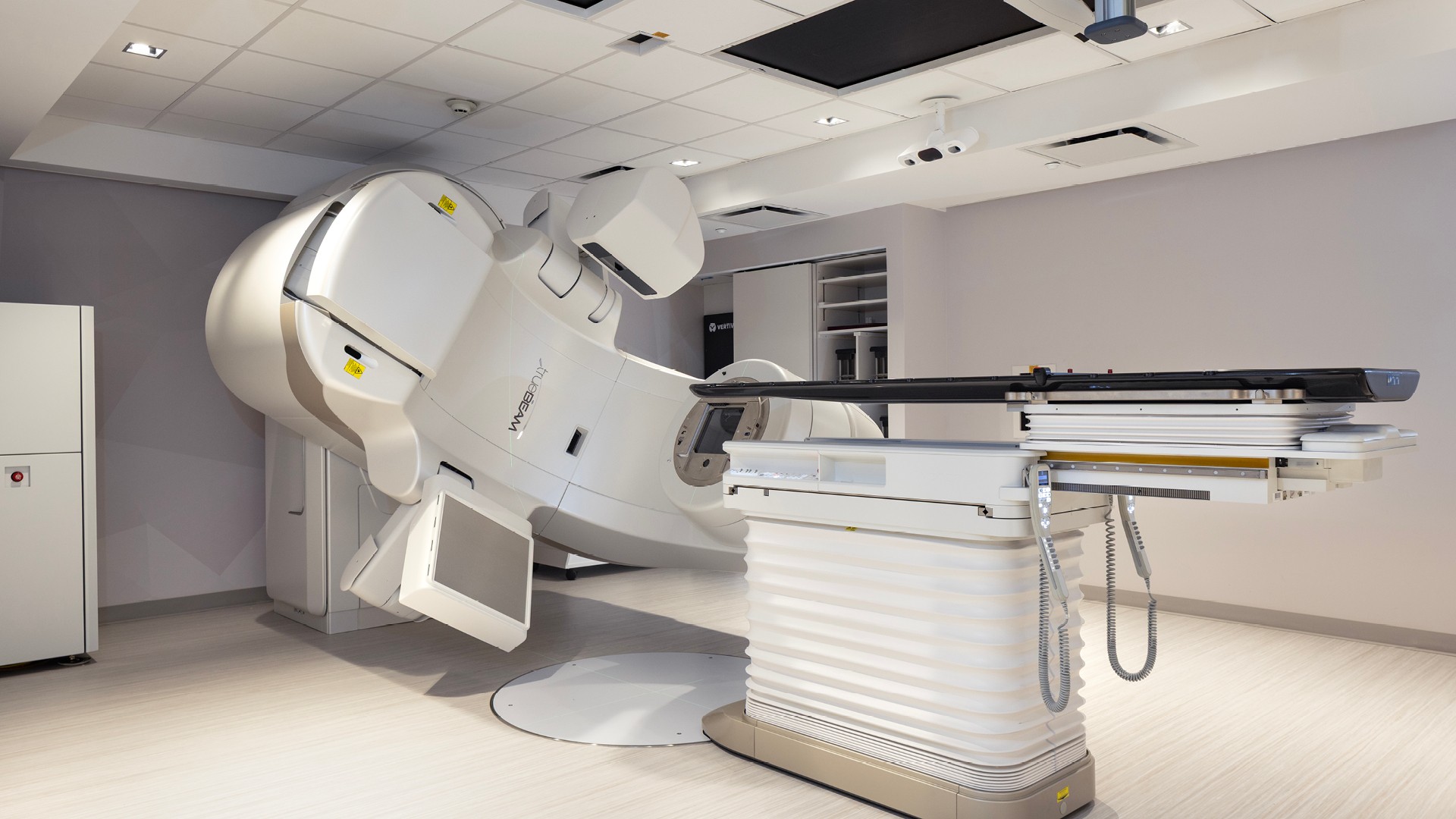 Radiation therapy treatment room Modern linear accelerator machine for advanced radiation therapy in a clinical room.