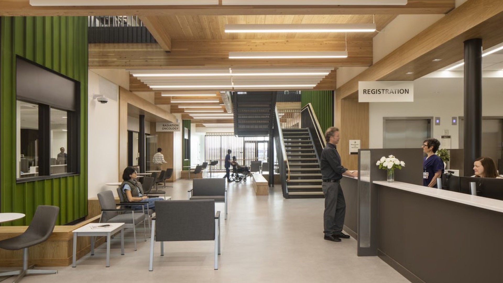 Redmond Cancer Center Modern medical clinic waiting area with registration desk, seating, and patients.