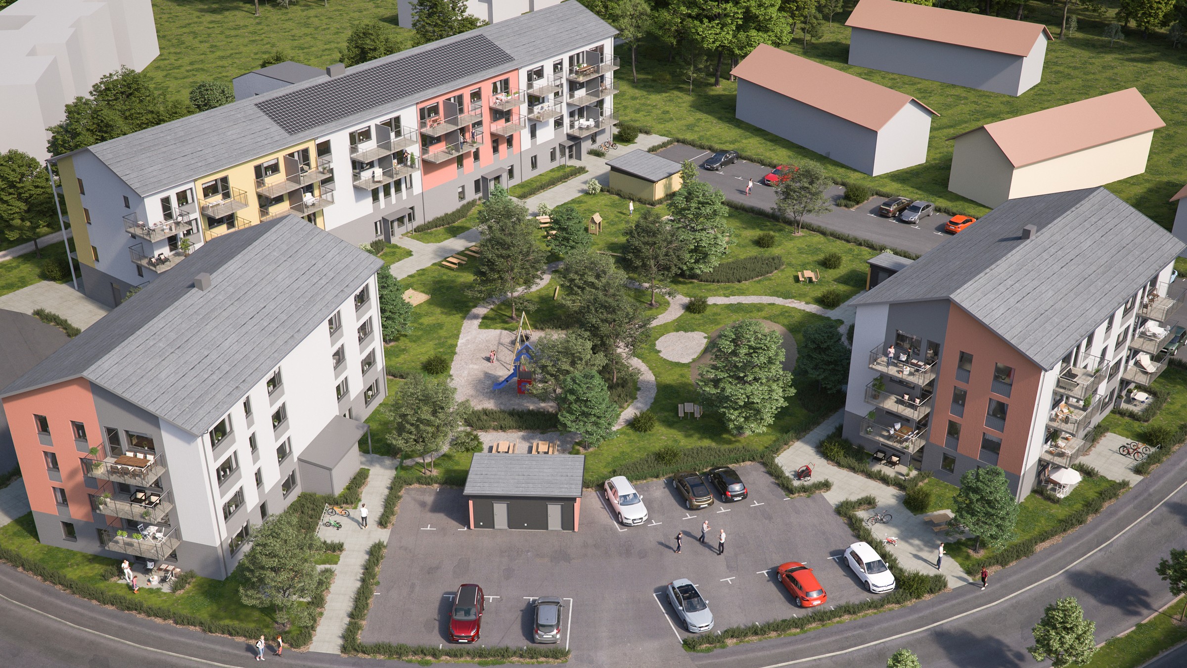 Flygvy över ett modernt bostadskomplex med färgglada byggnader och ett centralt lekplatsområde.