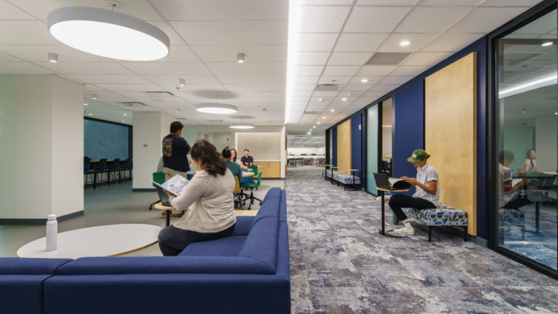 Modern collaborative workspace with people working and relaxing Modern office lounge with people working and relaxing in a bright, spacious area.